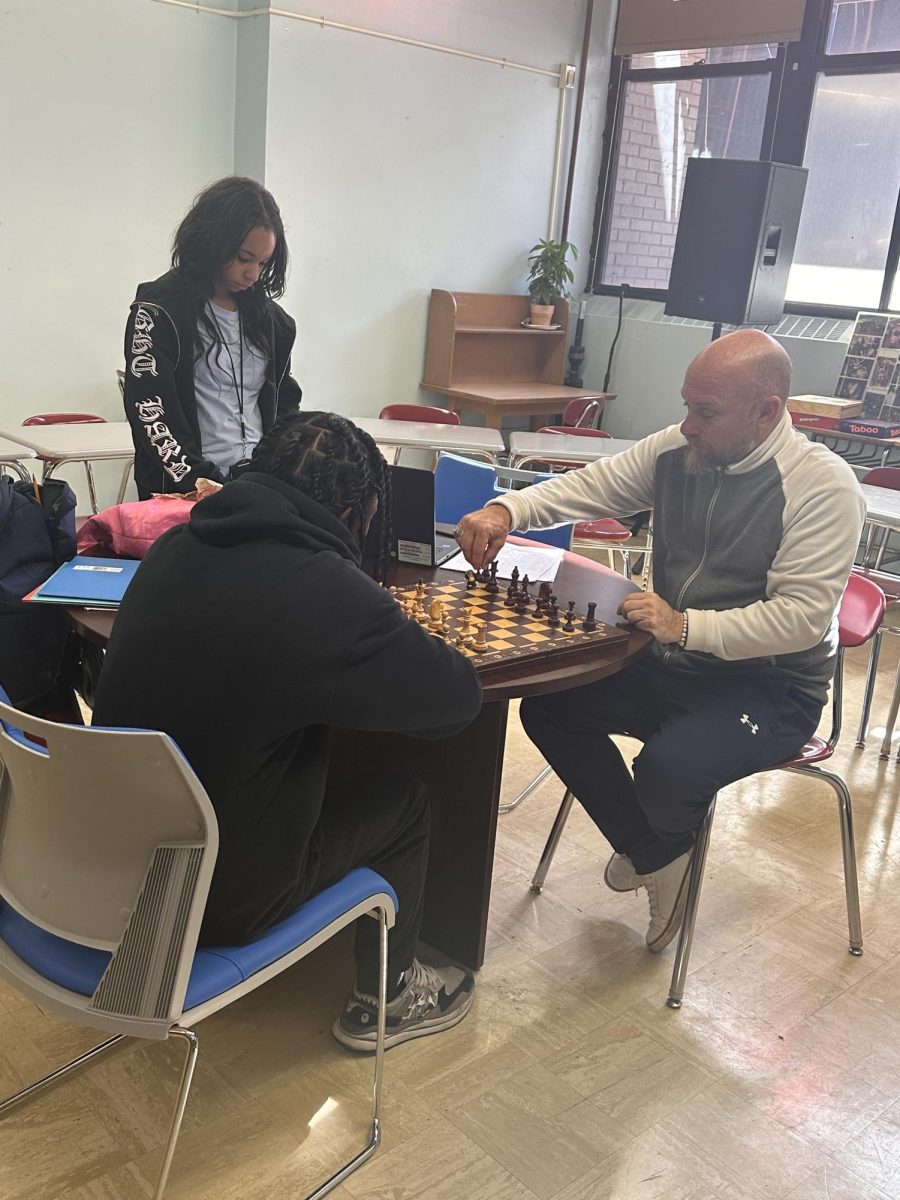 Mr.Satira playing chess with one of his students.