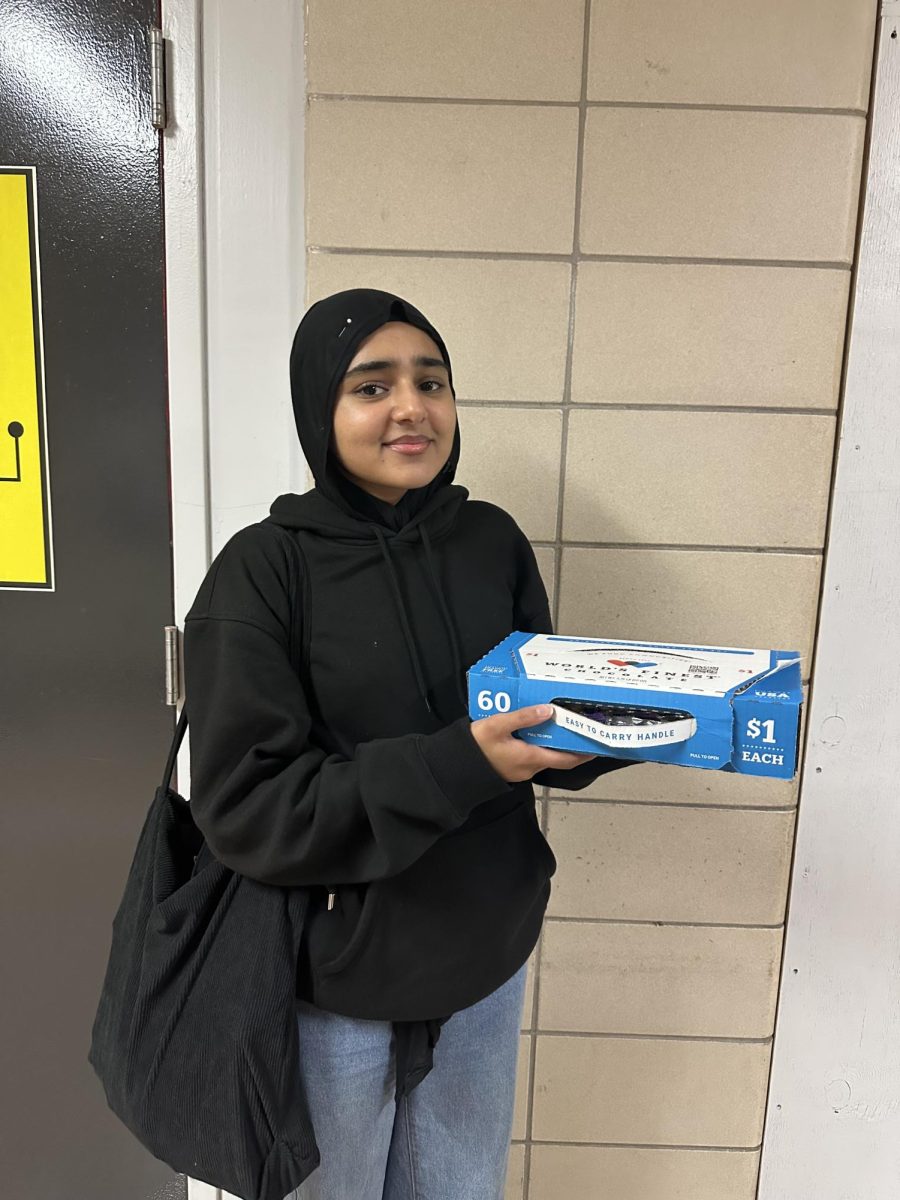 Senior Momna Asghar fundraising for senior dues by selling chocolates.