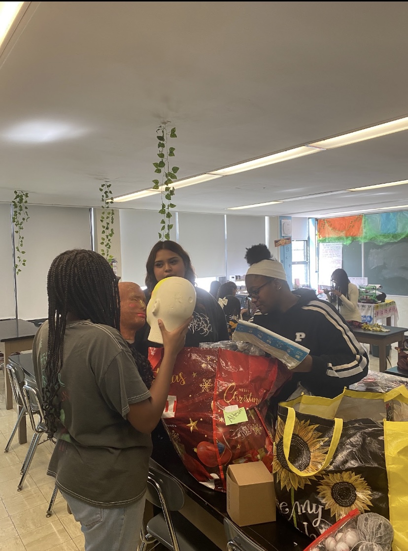 From left: Johannah Emmanu, Adriana Cristales, and Taylor Nancoo are going through Halloween decorations in preparation of Senior Scare Room.