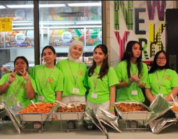 Dewey student volunteer's take a moment during the rush of serving hundreds of hungry students during the annual Thanksgiving Feast held in the cafeteria. 