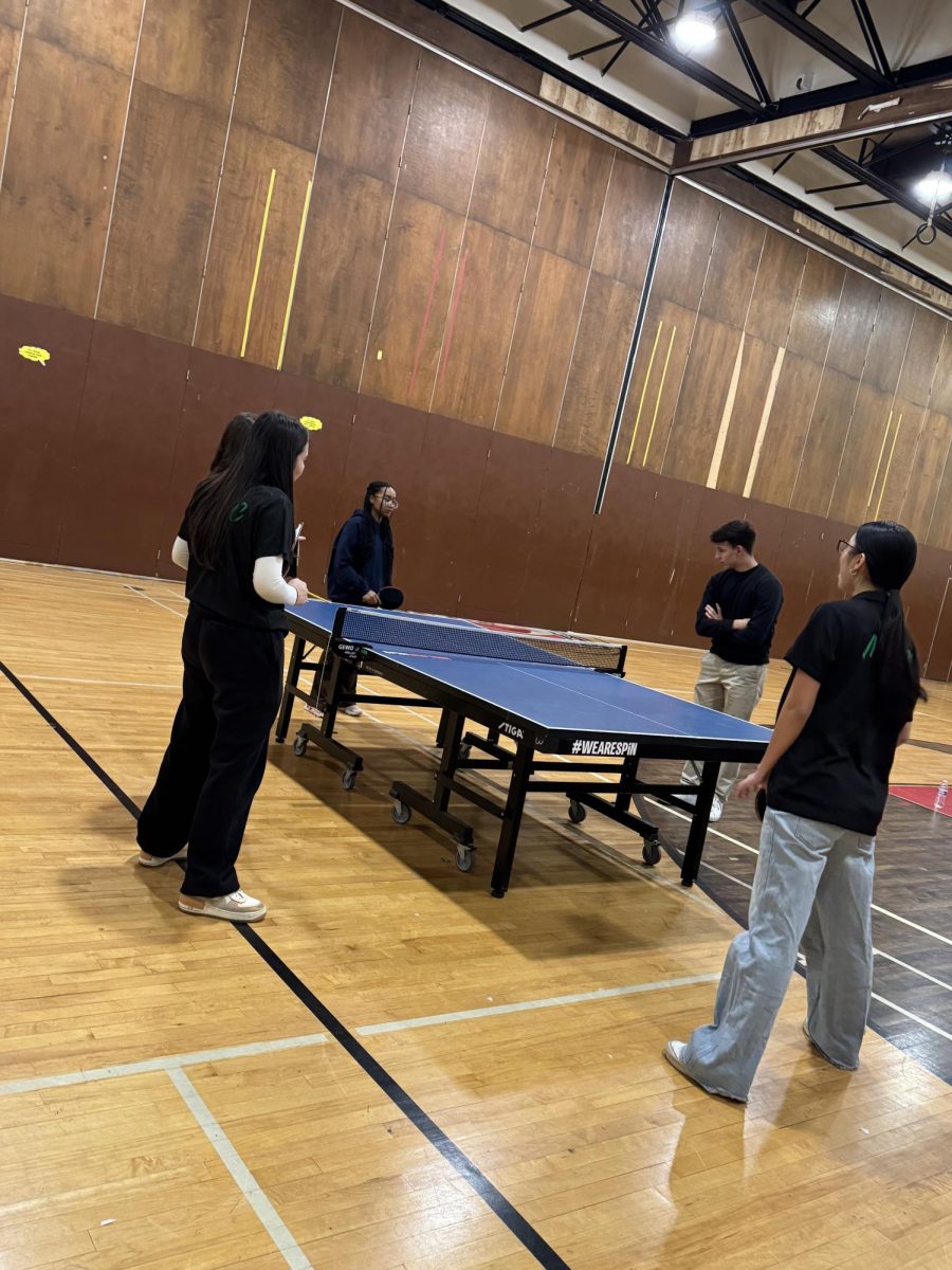 Dewey's Girl Table Tennis team participating in an exhibition match against Murrow.