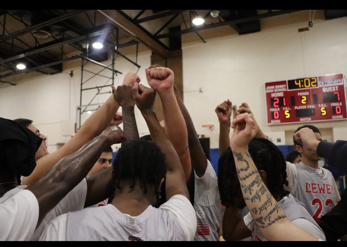 The boys basketball team huddled up in a timeout during the second quarter of their 67-47 win over Lafayette on Tuesday, November 26.