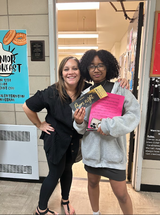The winner of the 2025 Prom Ticket Scavenger Hunt, senior Eve Smith, and Ms. Doceti outside room 137.