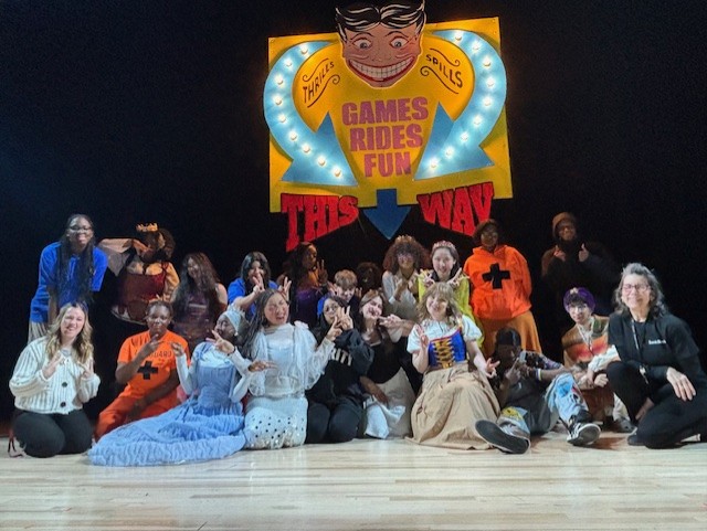 Cast, crew, and tech members involved with Game of Tiaras take a moment to appreciate their handcrafted set design and new auditorium, which opened for student use earlier this year. 