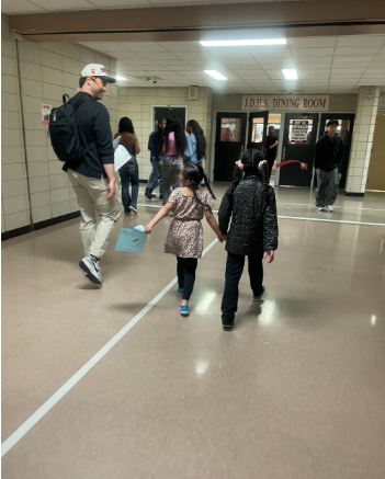 Mr. Pagano walks through the first floor with Mr. Vazequez's children. 