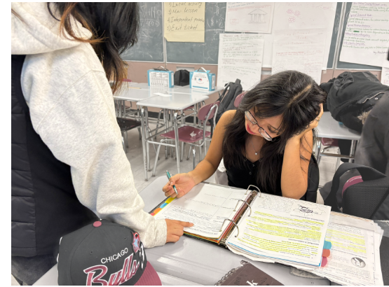 Student Study Club members helping each other complete their US history homework.