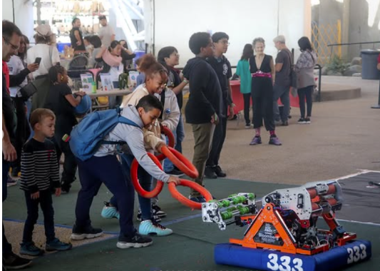 Robotics students attracting young minds interested in STEM at the 2024 Maker Faire in Coney Island.