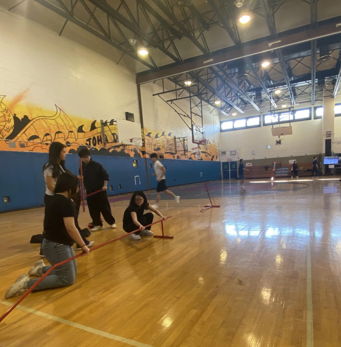 Team members setting up the badminton nets on March 10, 2026.