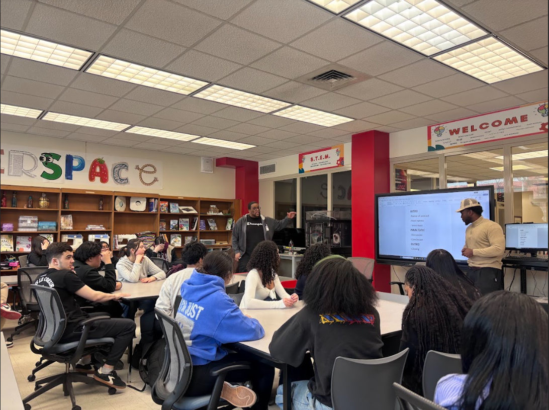 Instructors from The Thrive Collective, a community based organization, instructing students in Ms. Petrillo's class what makes an effective podcast outline.