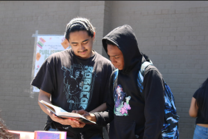 Students attending the publishing party sampling a Dewey freshman's novel. 