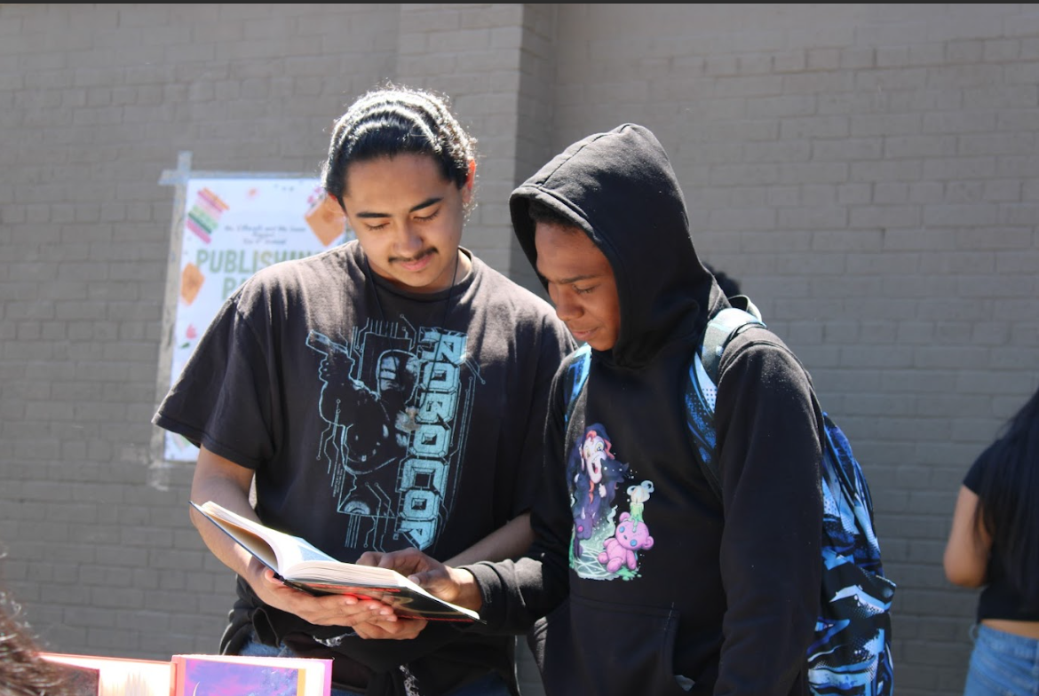Students attending the publishing party sampling a Dewey freshman's novel. 